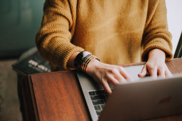 person in front of a laptop typing